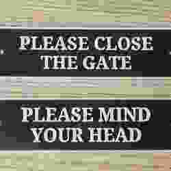 A Simple cose the gate sign and mind your head sign