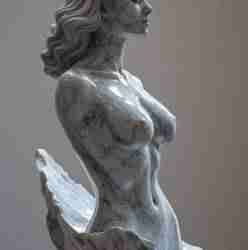 A finely crafted marble sculpture captures the graceful form of a woman in profile.