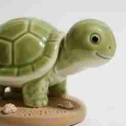 Smiling Ceramic Turtle on Sandy Base