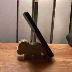 Dinosaur-shaped cell phone holder or holder