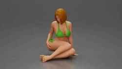 Woman in bikini sitting gracefully on floor with relaxed pose